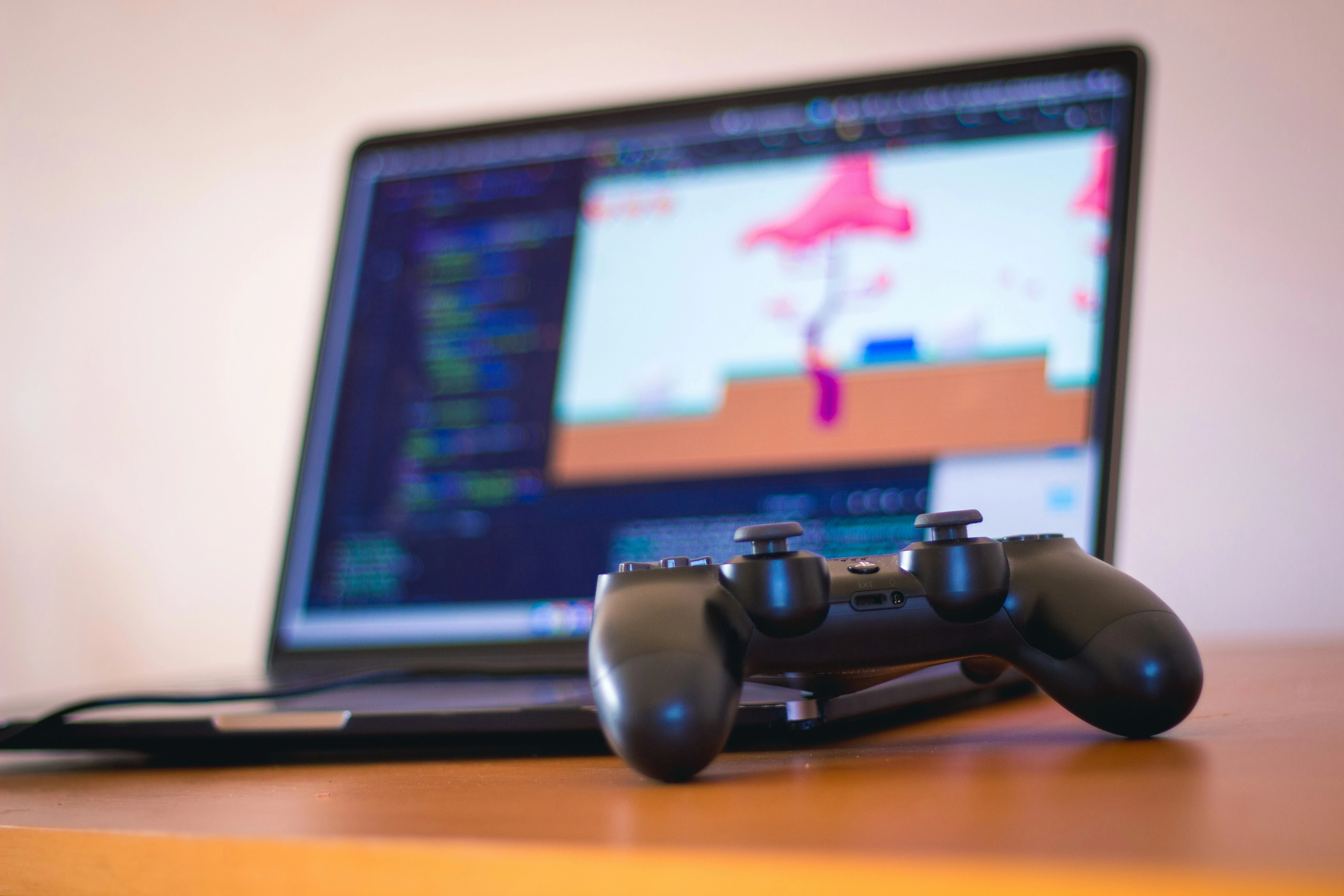 Game controller with blurred laptop.