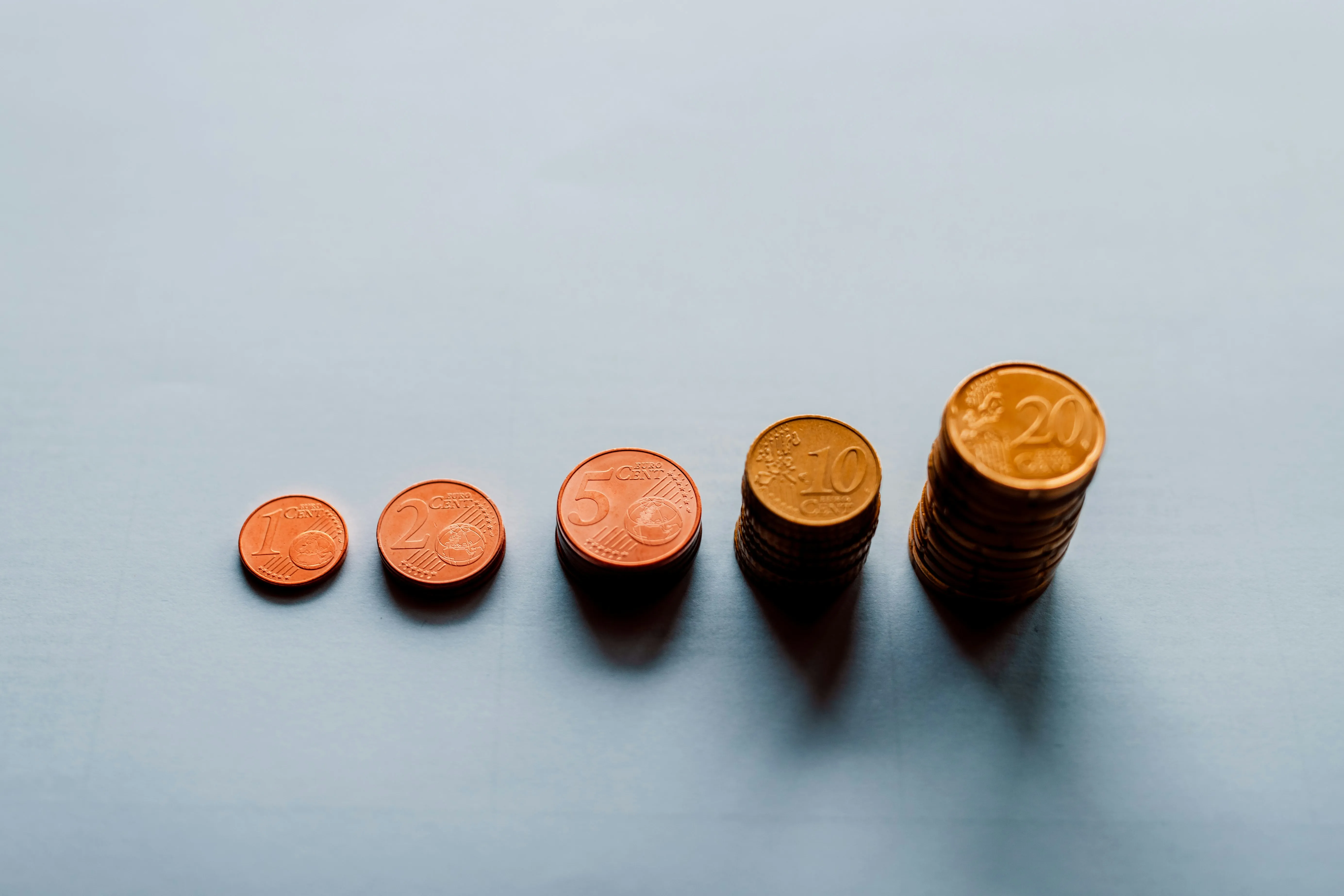 coins arranged by value on a surface.​