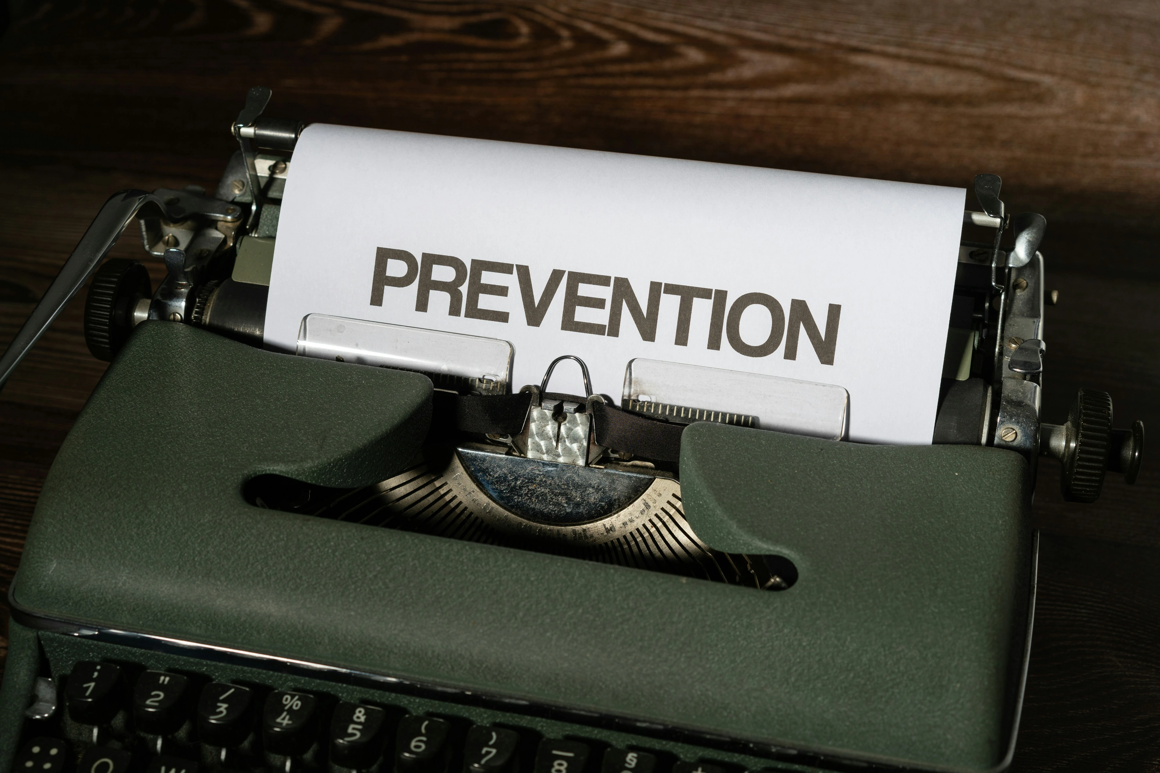 Vintage typewriter with the word 'PREVENTION' on paper.