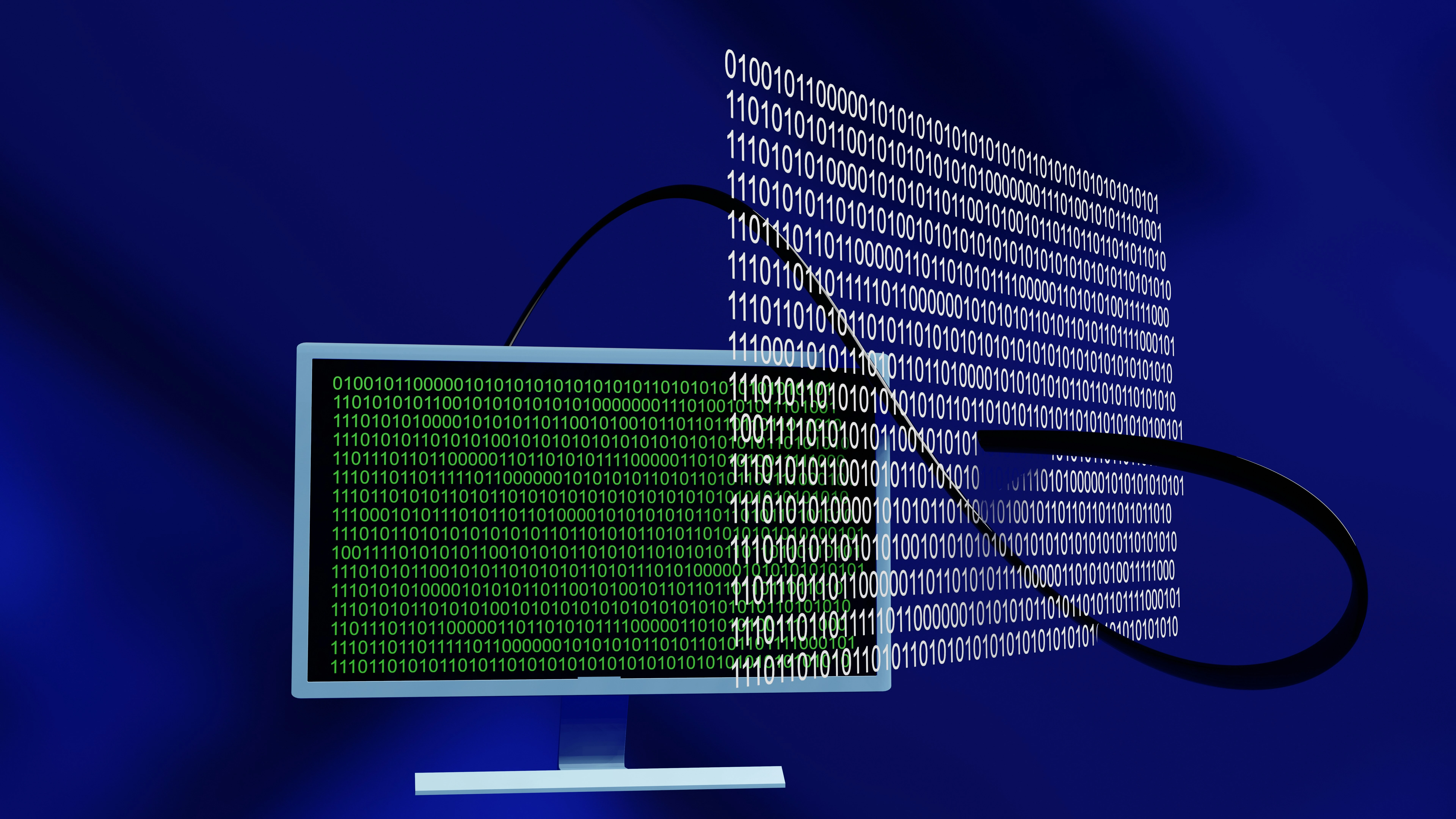Computer monitor displaying green binary code on a dark background.​​