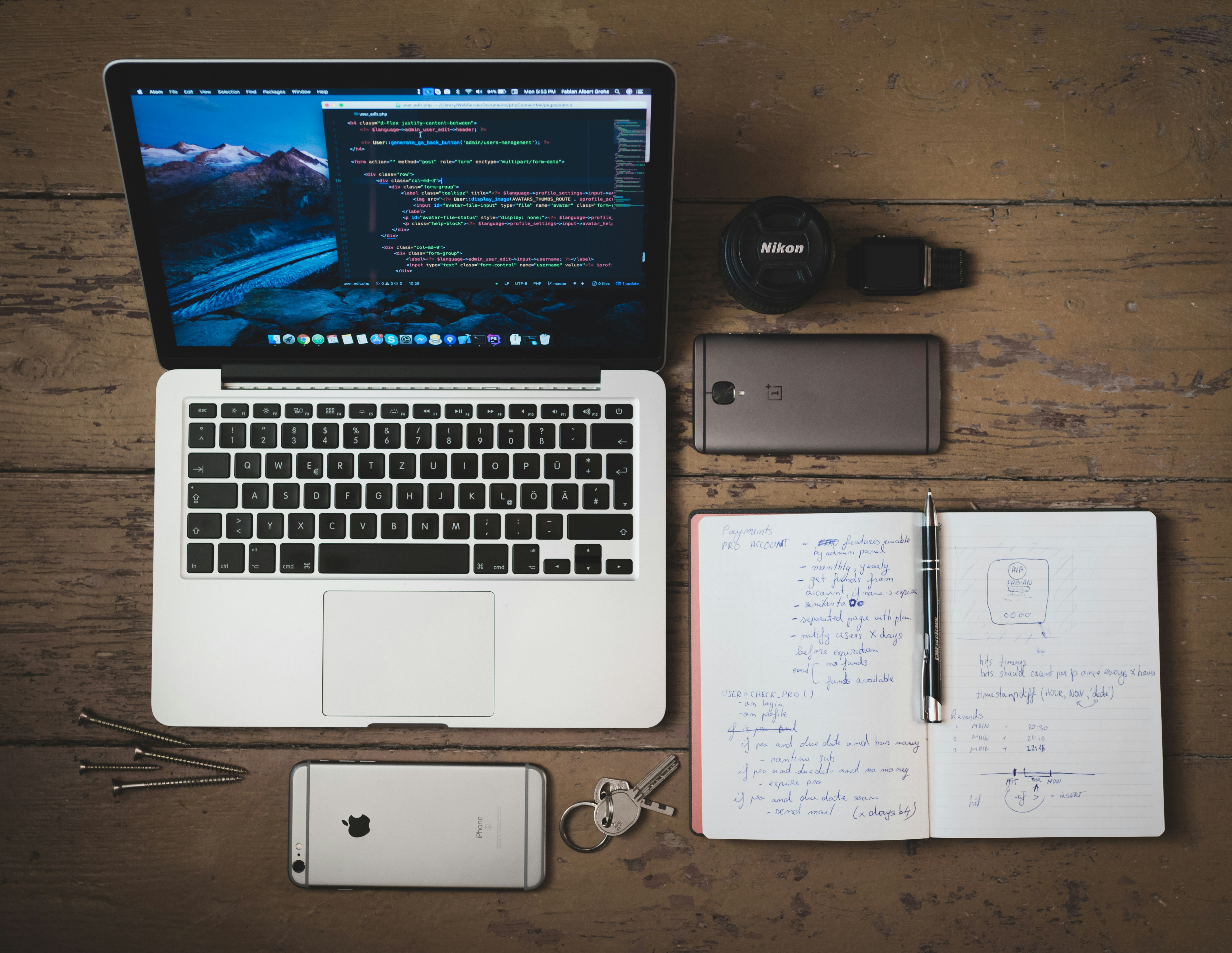 Workspace with laptop, notebook, and handwritten notes.
