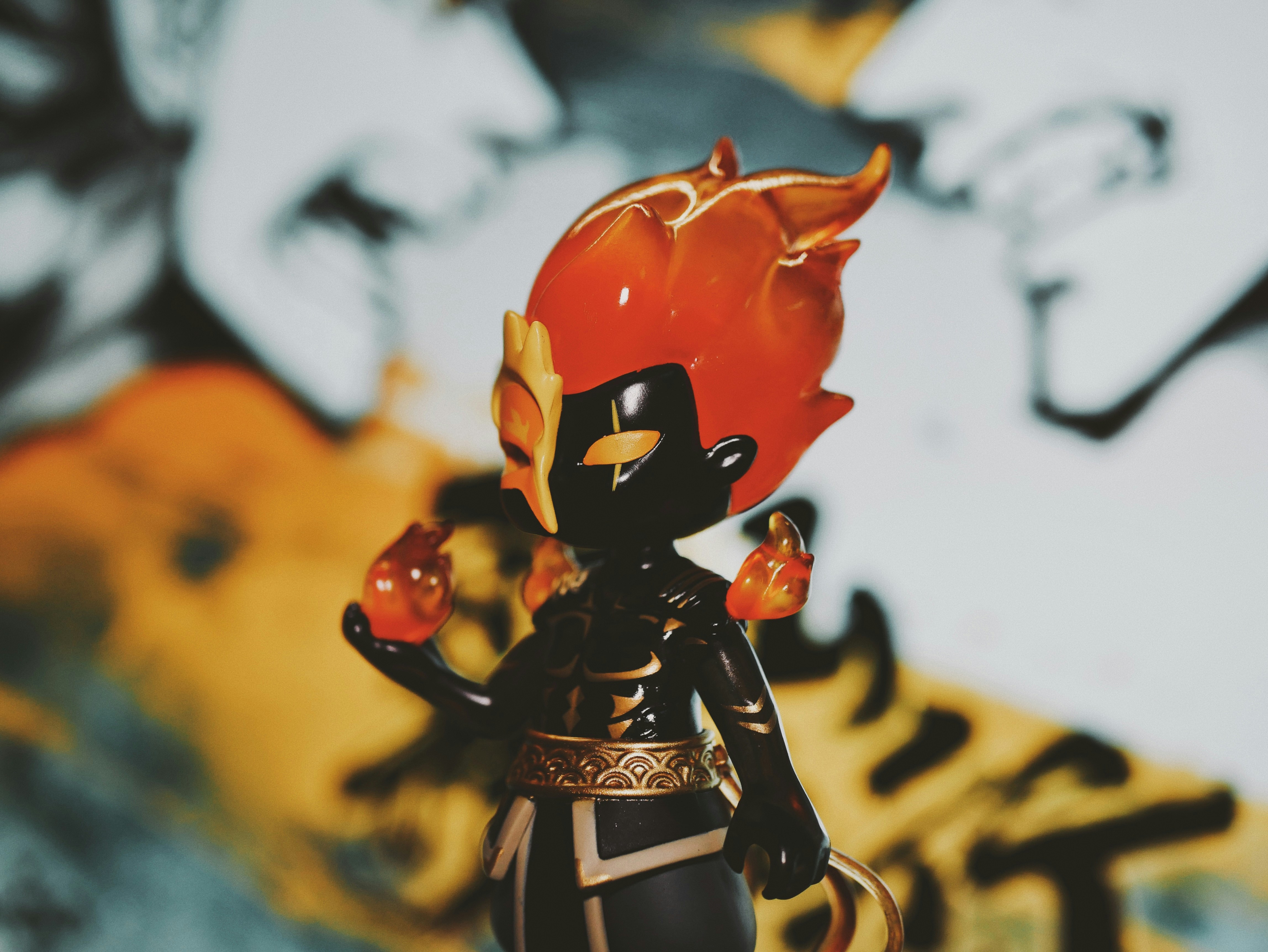 Fiery-themed figurine with golden accents