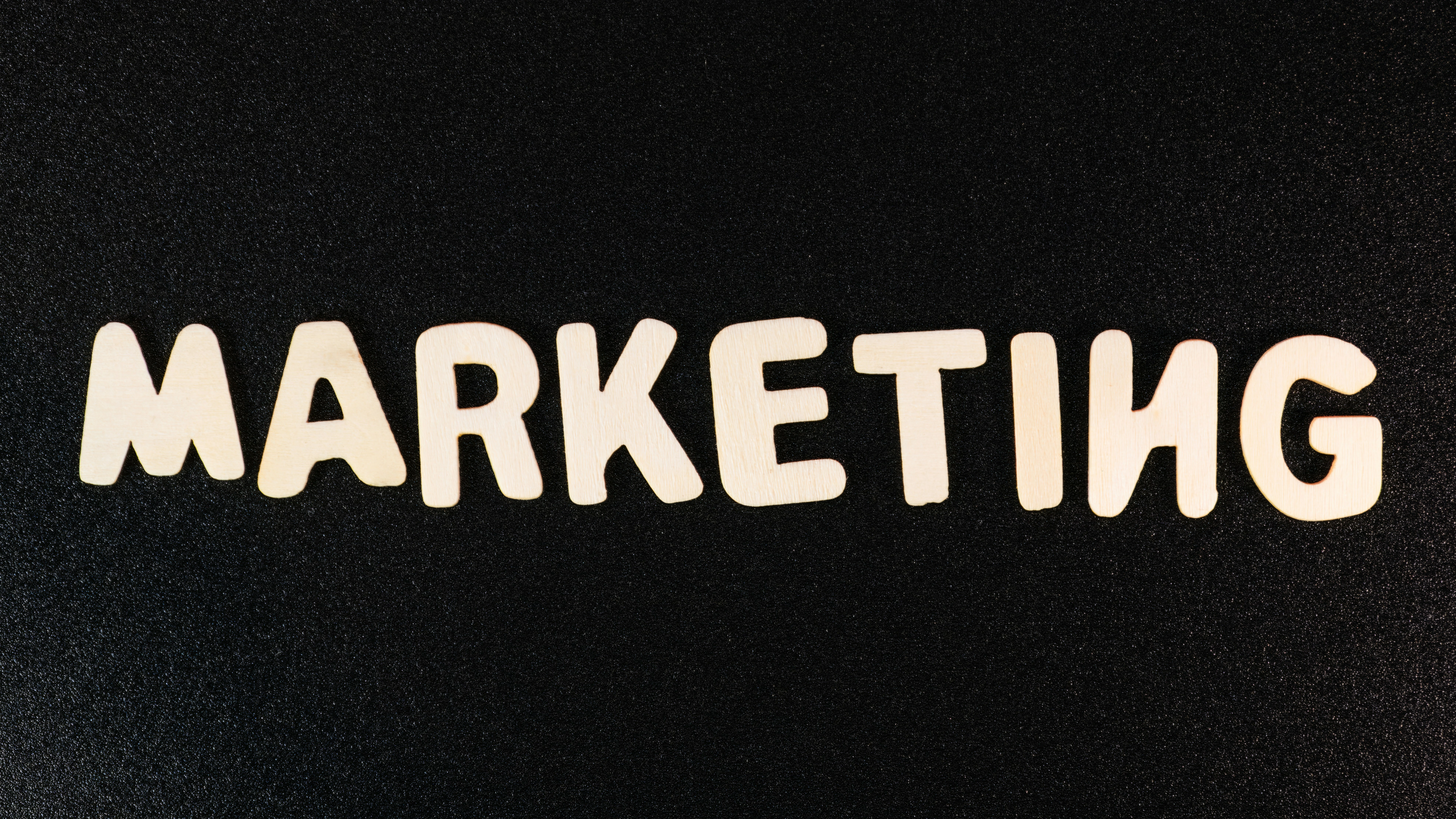 The word 'MARKETING' spelled out in wooden letters