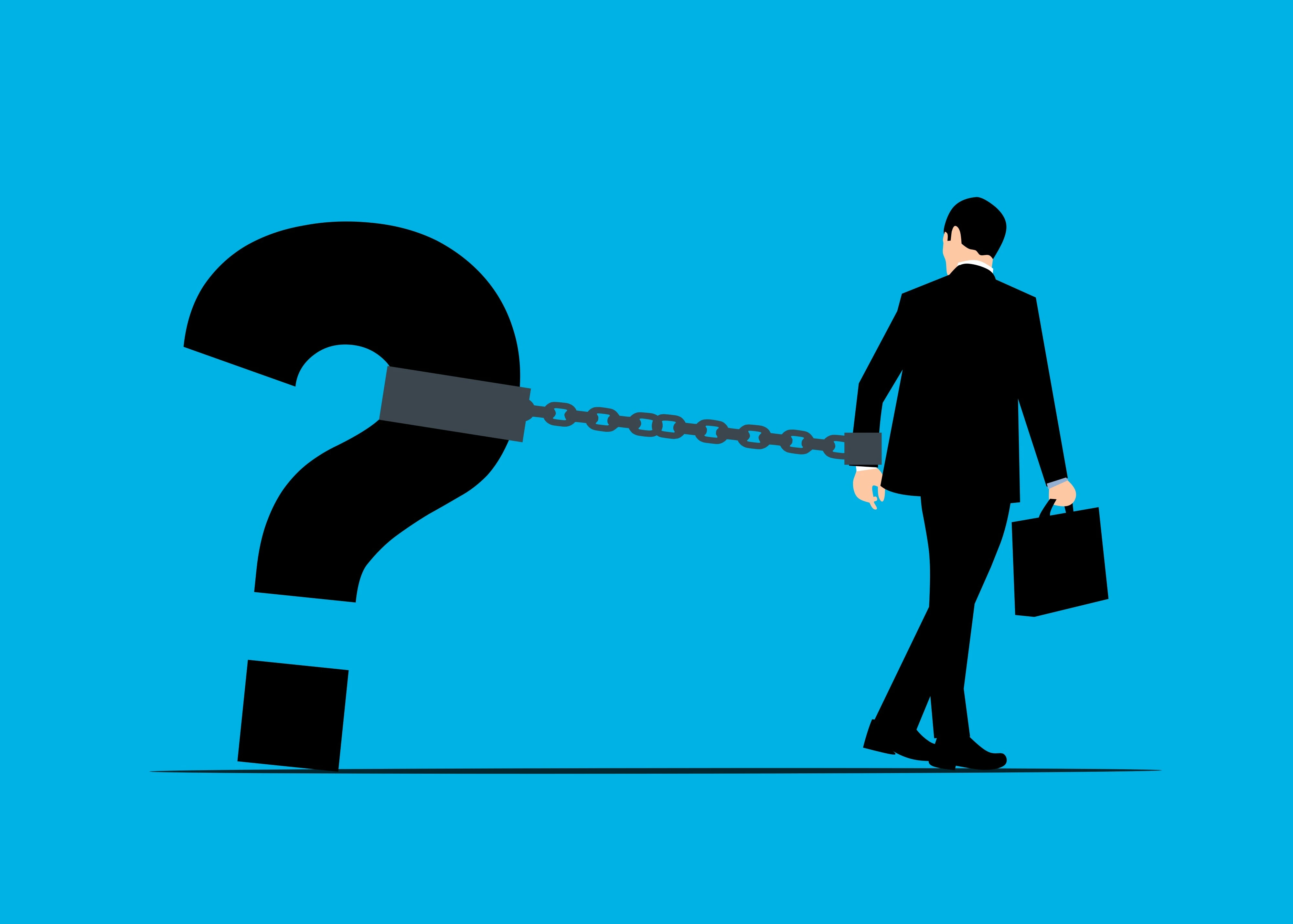 A man in a suit chained to a large black question mark